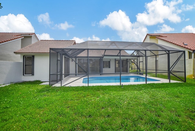 view of swimming pool featuring a yard and glass enclosure