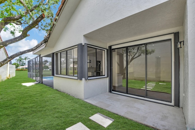 doorway to property featuring a yard