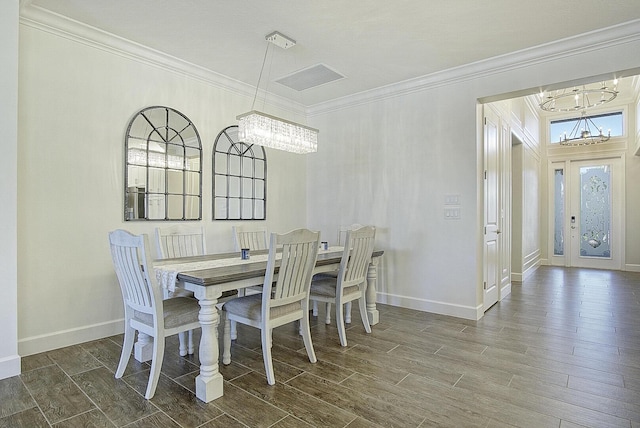 dining space featuring ornamental molding and a notable chandelier