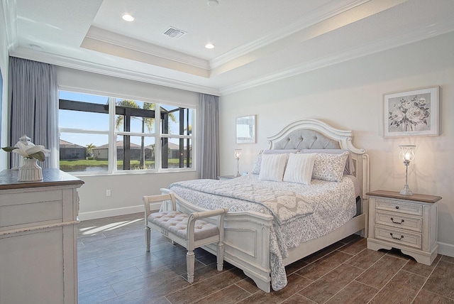 bedroom featuring ornamental molding and a tray ceiling