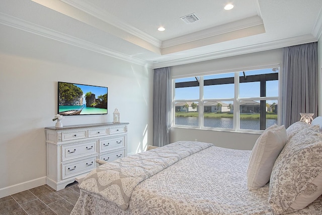 bedroom featuring a raised ceiling and ornamental molding