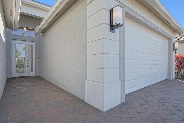 exterior space with french doors and a garage