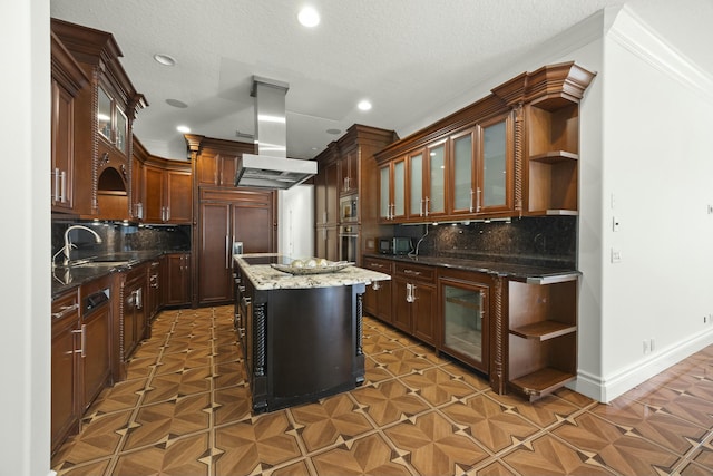 kitchen with sink, a center island, tasteful backsplash, ventilation hood, and built in appliances