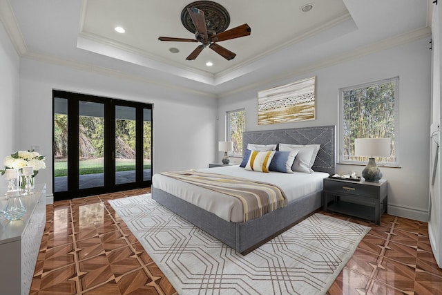 bedroom featuring access to outside, a tray ceiling, ceiling fan, and crown molding