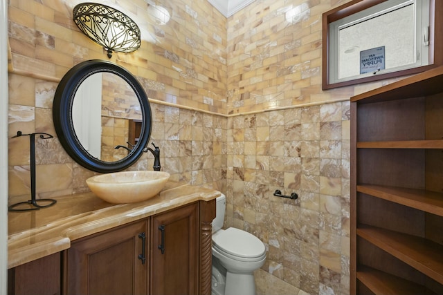 bathroom featuring tile walls, toilet, and vanity