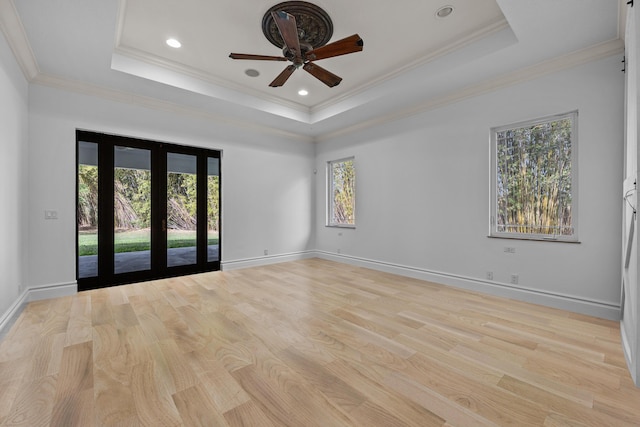 unfurnished room featuring french doors, crown molding, and a raised ceiling