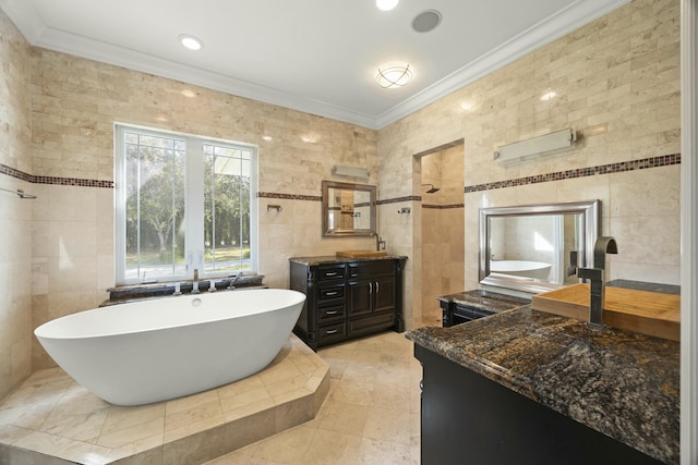 bathroom featuring vanity, a bath, tile patterned floors, crown molding, and tile walls