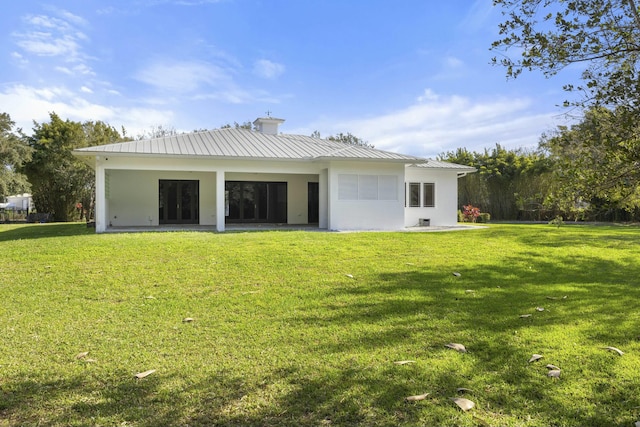 back of house with a yard