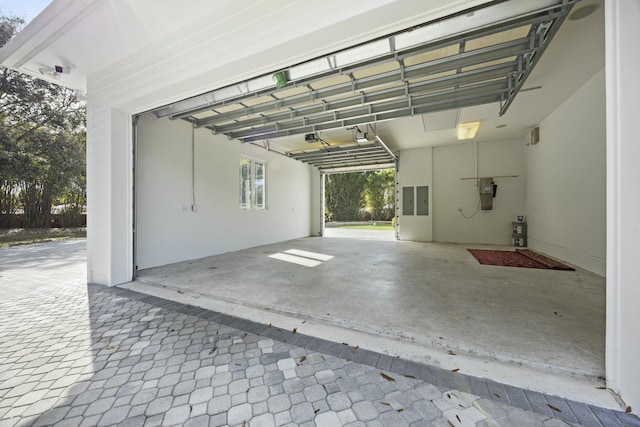 garage with electric panel and a garage door opener