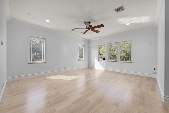 spare room featuring ceiling fan, light hardwood / wood-style flooring, and crown molding