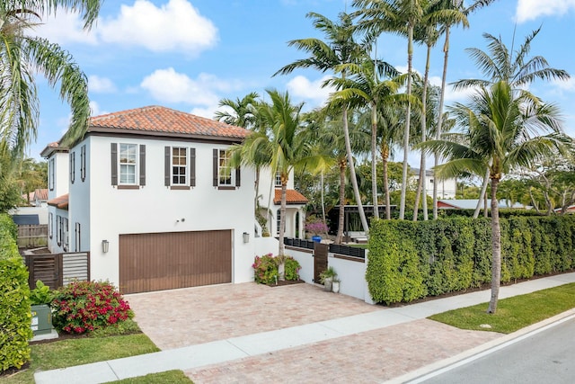 mediterranean / spanish-style home featuring a garage