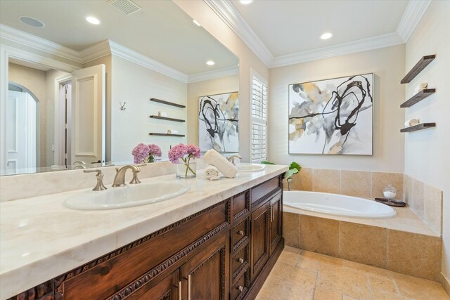 bathroom with a relaxing tiled tub, vanity, and ornamental molding