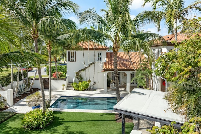 view of pool with a yard and a patio