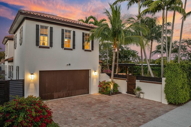 mediterranean / spanish house featuring a garage