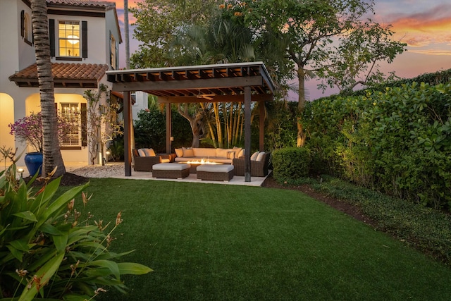 yard at dusk featuring a patio area, an outdoor hangout area, and a pergola