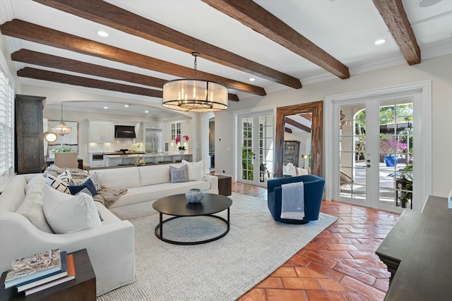 living room with beam ceiling, french doors, and a chandelier