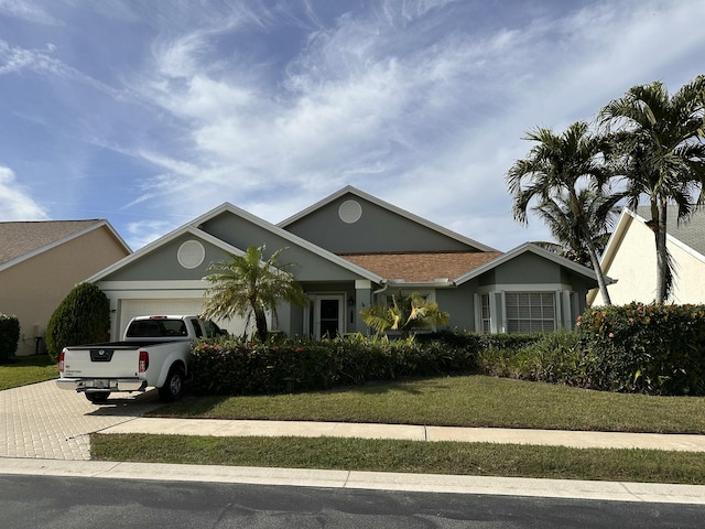 view of front facade featuring a front lawn and a garage