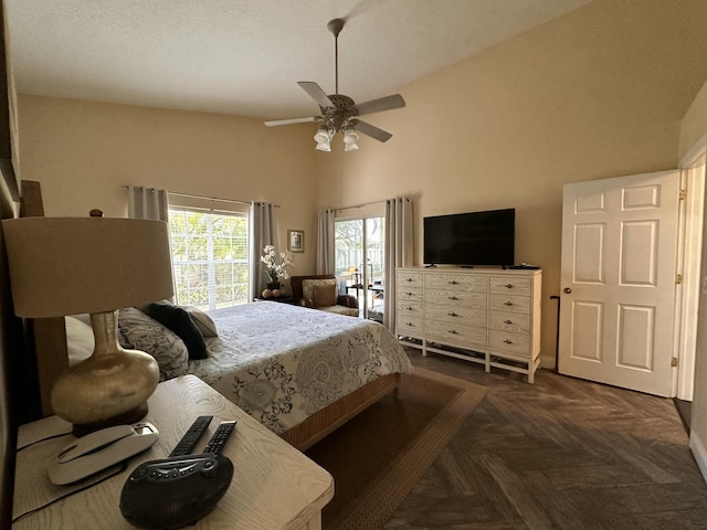 bedroom featuring a towering ceiling, dark parquet floors, and ceiling fan