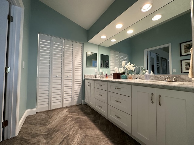 bathroom featuring vanity, parquet floors, and lofted ceiling