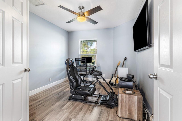 office space featuring ceiling fan and light hardwood / wood-style flooring