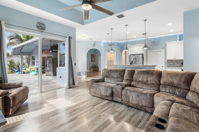 living room featuring light hardwood / wood-style flooring and ceiling fan