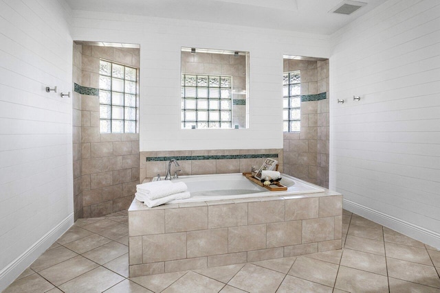 bathroom featuring tiled tub and tile patterned floors