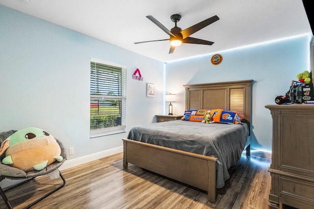 bedroom with ceiling fan and hardwood / wood-style floors