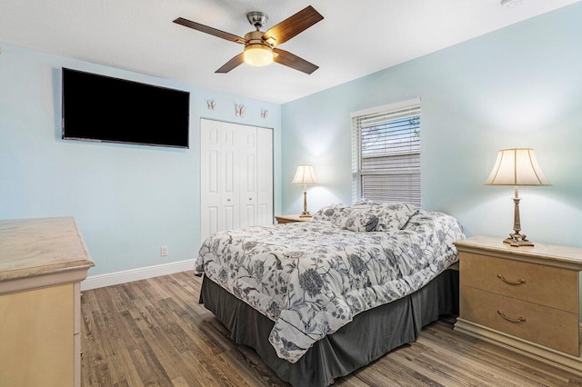 bedroom featuring hardwood / wood-style floors, a closet, and ceiling fan