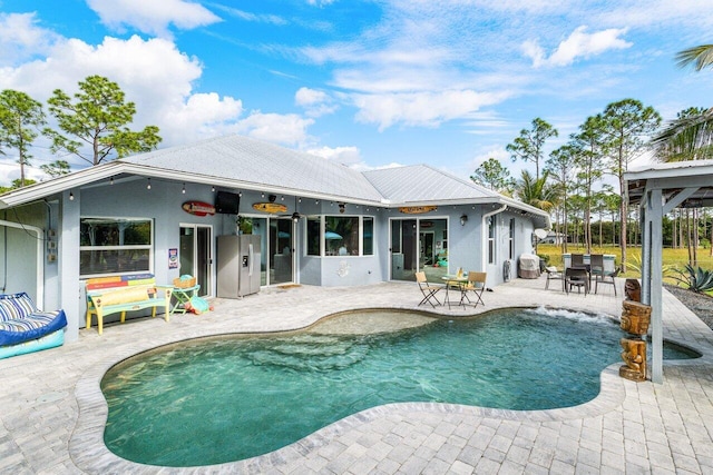 view of swimming pool with a patio and ceiling fan