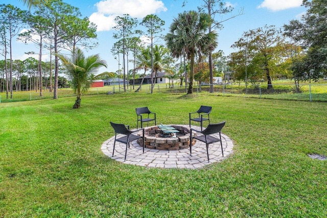 view of yard featuring an outdoor fire pit and a patio