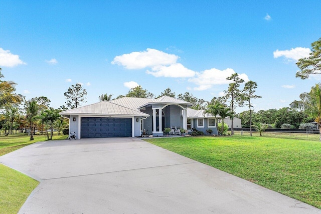 view of front of property featuring a garage and a front yard