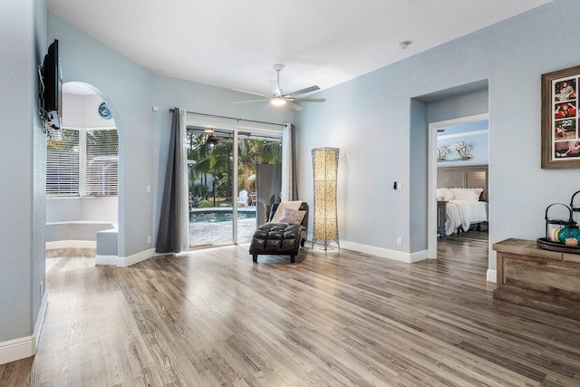 sitting room featuring wood-type flooring and ceiling fan