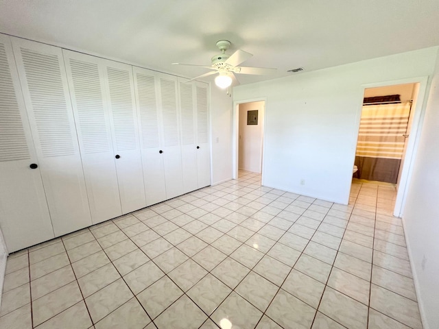 unfurnished bedroom featuring light tile patterned floors, a closet, and ceiling fan