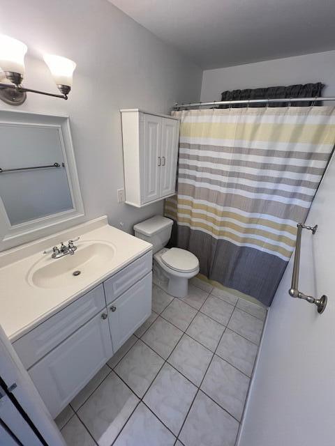 bathroom with vanity, tile patterned floors, and toilet