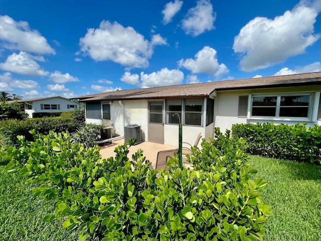 back of house featuring a patio area and central air condition unit