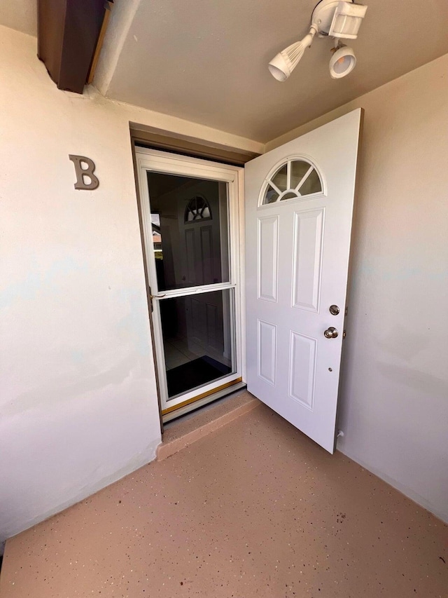 entrance to property featuring ceiling fan