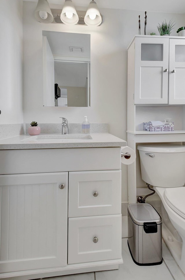 bathroom featuring vanity and toilet