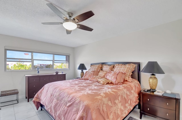 tiled bedroom featuring a textured ceiling and ceiling fan