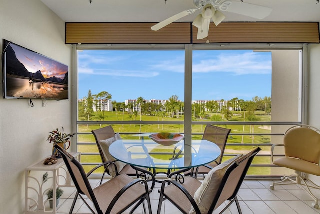 sunroom featuring ceiling fan