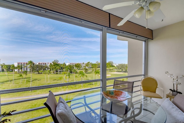 sunroom / solarium featuring ceiling fan