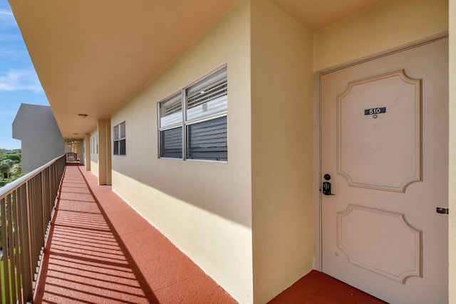 view of exterior entry featuring a balcony