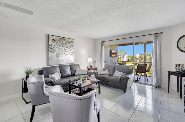 tiled living room featuring ceiling fan and a textured ceiling