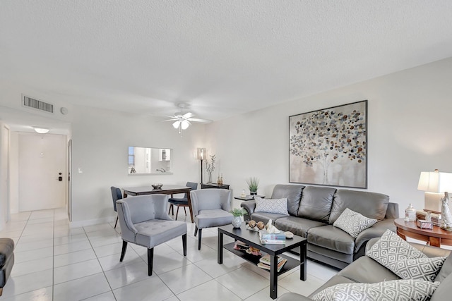 tiled living room featuring ceiling fan and a textured ceiling