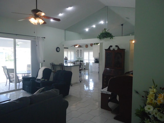 tiled living room featuring ceiling fan and high vaulted ceiling