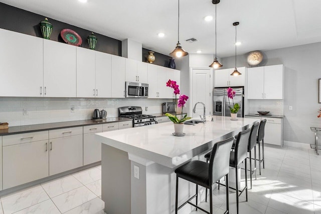 kitchen featuring visible vents, decorative backsplash, appliances with stainless steel finishes, a kitchen bar, and marble finish floor