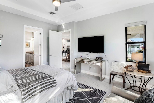 bedroom featuring ceiling fan and connected bathroom