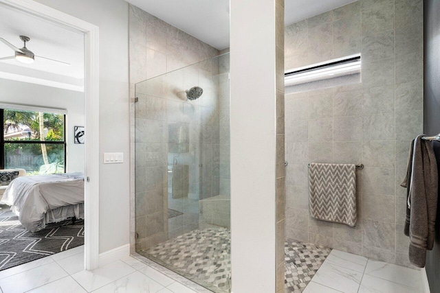 bathroom with tiled shower and ceiling fan