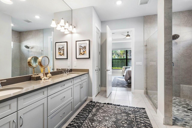 bathroom featuring ceiling fan, vanity, and tiled shower