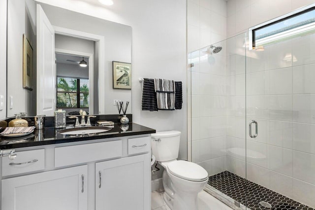 bathroom featuring plenty of natural light, toilet, walk in shower, and vanity