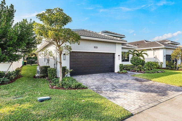 view of front of house with a garage and a front lawn